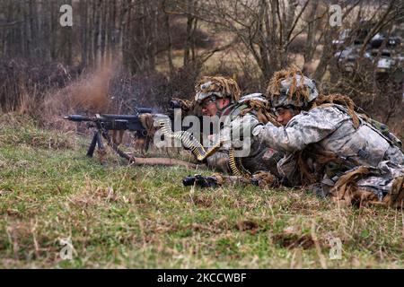 U.S. Soldiers fire at simulated enemy forces. Stock Photo