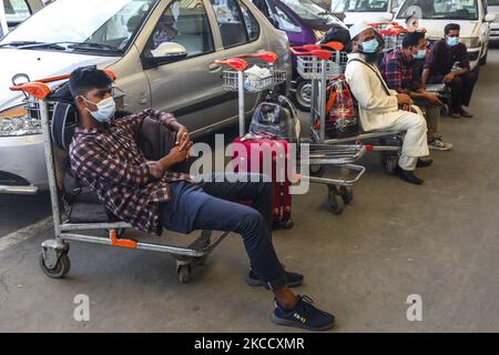 Migrant workers waits for the flights as those are cancelled as authorities concerned of the respective destinations – Riyadh, Dammam, Dubai, and Jeddah – did not give landing permission and due to shortage of passengers at Hazrat Shahjalal International Airport in Dhaka on April 17, 2021. The initiative to send Bangladeshi migrant workers back to their desired countries experienced a major hiccup at the beginning as most of the special flights scheduled for Saturday had to be cancelled. (Photo by Ahmed Salahuddin/NurPhoto) Stock Photo