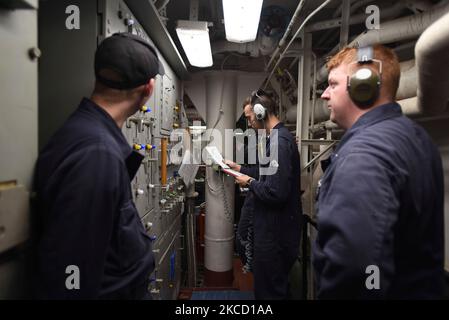Sailors participate in an engineering casualty drill in the main machinery room on USS Shoup. Stock Photo