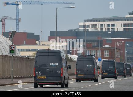 A line of Amazon Prime vans seen in the Titanic Quarter in Belfast. Packages are shipped to the delivery station from Amazon fulfillment and sorting centers and loaded onto vehicles for delivery to Amazon customers in the Belfast area. On Tuesday, April 20, 2021, in Belfast, Northern Ireland. (Photo by Artur Widak/NurPhoto) Stock Photo