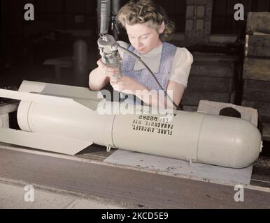 Woman worker assembling flare casings at a factory, 1942. Stock Photo