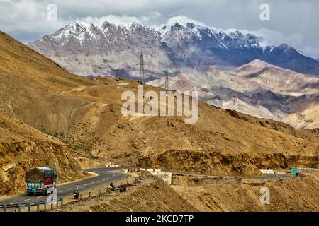 Vehicles travel along the Srinagar-Leh highway through the Namika La Pass (Namika Pass) at an elevation of 3,700 m (12,139 ft) in Zanskar, Ladakh, Jammu and Kashmir, India. Known as the Pillar of the Sky Pass Namika La is one of two high passes between Kargil and Leh (the other even higher pass is the Fotula Pass). (Photo by Creative Touch Imaging Ltd./NurPhoto) Stock Photo