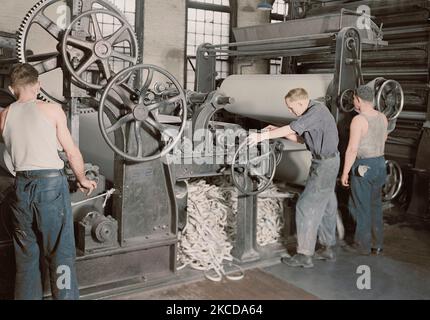 Men rewinding paper from reel at the American Writing Paper Co., 1936. Stock Photo