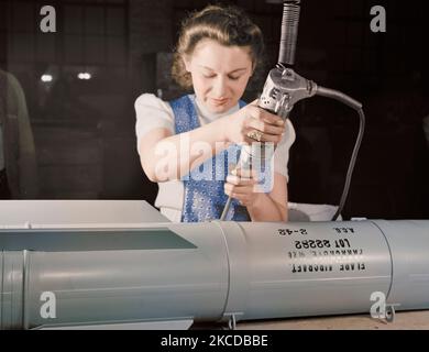 Woman worker assembling flare casings at a factory, 1942. Stock Photo