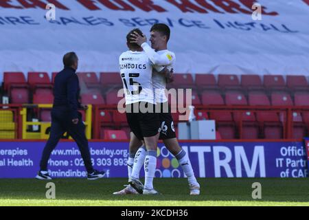 LONDON, UK. APRIL 24TH. Sammie Szmodics of Peterborough and Harrison Burrows of Peterborough celebrating the win during the Sky Bet League 1 match between Charlton Athletic and Peterborough at The Valley, London, England on 24th April 2021. (Photo by Ivan Yordanov/MI News/NurPhoto) Stock Photo