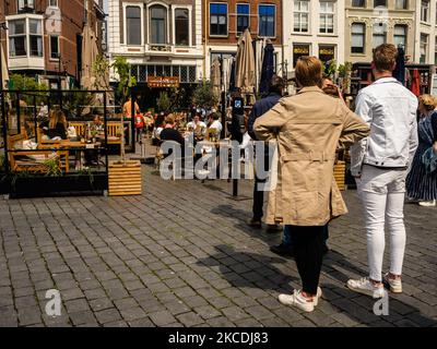 People are waiting in line to take a sit on a terrace, during the first day that stores and terraces allowed to open again with Corona measures, in Nijmegen, The Netherlands, on April 28th, 2021. (Photo by Romy Arroyo Fernandez/NurPhoto) Stock Photo