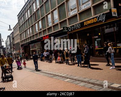 There is already a long line of people waiting for outside to get in one of the New Yorker stores in the city, during the first day that stores and terraces allowed to open again with Corona measures, in Nijmegen, The Netherlands, on April 28th, 2021. (Photo by Romy Arroyo Fernandez/NurPhoto) Stock Photo