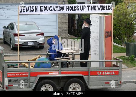 Hasidic Jews hold a vehicle parade through a Jewish neighbourhood to celebrate Lag BaOmer (Lag B'Omer) in Toronto, Ontario, Canada, during the COVID-19 pandemic on April 30, 2021. Lag BaOmer marks the anniversary of the death of Rabbi Shimon bar Yochai, a Mishnaic sage and leading disciple of Rabbi Akiva in the 2nd century, and the day on which he revealed the deepest secrets of kabbalah, a landmark text of Jewish mysticism. There are several customs and practices on Lag BaOmer, including the lighting of bonfires and pilgrimages to the tomb of Bar Yochai in Israel. (Photo by Creative Touch Ima Stock Photo