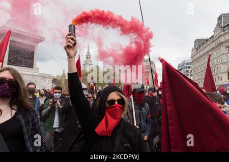 LONDON, UNITED KINGDOM - May 01, 2021: Demonstrators set off flares during 'Kill the Bill' protest march from Trafalgar Square through central London to oppose government’s Police, Crime, Sentencing and Courts Bill (PCSC Bill), which would give police officers and the Home Secretary new powers to impose conditions on protests and public processions, on 01 May, 2021 in London, England. The protest organised by a coalition of different groups including Black Lives Matter and Women’s Strike Assembly is part of a national day of action with at least 46 protests happening across the UK on Internati Stock Photo