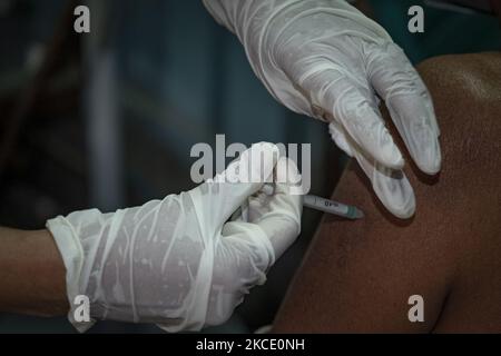 A health care officer is inoculating a dosage of Bharat Biotech's Covaxin vaccine during the mass vaccination drive. On May 4, 2021 in Kolkata, India. (Photo by Dipayan Bose/NurPhoto) Stock Photo