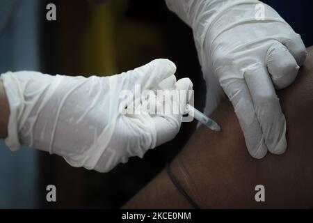 A health care officer is inoculating a dosage of Bharat Biotech's Covaxin vaccine during the mass vaccination drive. On May 4, 2021 in Kolkata, India. (Photo by Dipayan Bose/NurPhoto) Stock Photo