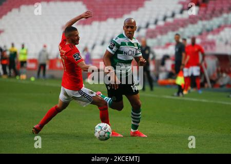João Mário midfielder of Sporting CP battle for the ball with Diogo Gonçalves of SL Benfica during the Liga NOS match between SL Benfica and Sporting CP at Estadio da Luz on 15th May, 2021 in Lisbon, Portugal. (Photo by Valter Gouveia/NurPhoto) Stock Photo