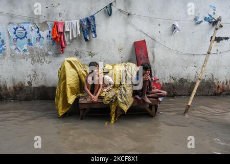 Two little girl tries to escape flood water , which is caused due to effects of High tide and Cyclone Yaas , in Kolkata , India , on 26 May 2021 . (Photo by Debarchan Chatterjee/NurPhoto) Stock Photo