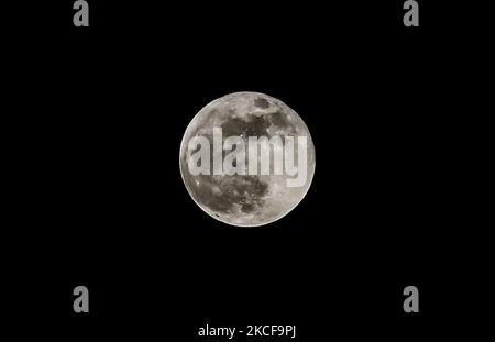 Super blood moon is seen in Gaza City, on 26 May,2021.A supermoon occurs when a full moon is at its closest point to Earth in its elliptical orbit. (Photo by Sameh Rahmi/NurPhoto) Stock Photo