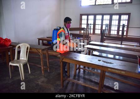 Municipal workersÂ during Â SanitizationÂ a Covid vaccination centre in Nagaon district in the northeastern state of Assam, India on May 29,2021 (Photo by Anuwar Hazarika/NurPhoto) Stock Photo