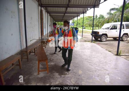 Municipal workersÂ during Â SanitizationÂ a Covid vaccination centre in Nagaon district in the northeastern state of Assam, India on May 29,2021 (Photo by Anuwar Hazarika/NurPhoto) Stock Photo