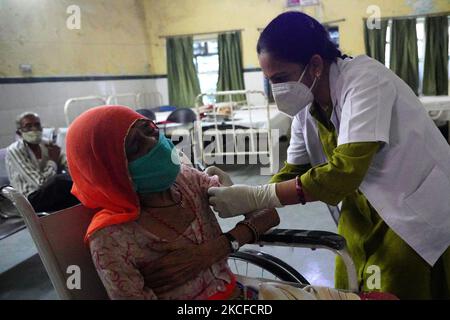 Indian Health worker Inoculates People with a dose of the Covid-19 ...