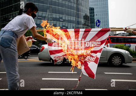 Members of the Korean University Student Progressive Association burn the Japanese war criminal flag to condemn the Tokyo Olympic Committee, which marks Dokdo Island, the territory of the Republic of Korea, as Japanese territory at across the Japanese Embassy on June 1st, 2020 in Seoul, South Korea. (Photo by Chris Jung/NurPhoto) Stock Photo