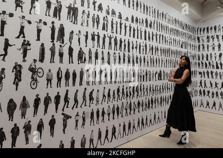 LONDON, UNITED KINGDOM - JUNE 02, 20201: A woman looks at 'The Chronicles of New York City' (2019) by JR (French, born 1983) during a press view for the 'JR: Chronicles' exhibition (04 June - 03 October 2021) at Saatchi Gallery on June 02, 2021 in London, England. 'JR: Chronicles', curated by Sharon Matt Atkins and Drew Sawyer from the Brooklyn Museum, is the largest solo museum exhibition to date of the internationally recognised French artist JR, featuring some of his most iconic projects from the past fifteen years. (Photo by WIktor Szymanowicz/NurPhoto) Stock Photo