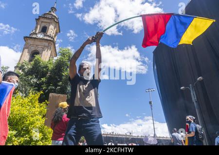 An man waves a Colombia flag at the protest in Bogota, in the fifth week of protests against the national government of Colombia. On June 2, 2021 in Bogota, Colambia. (Photo by Daniel Garzon Herazo/NurPhoto) Stock Photo