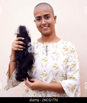 22-Year old Varsha Kumawat poses for a photograph after shaving her head to donate hair for the cancer patients in Ajmer, In the Indian state of Rajasthan on 13 June 2021. (Photo by Himanshu Sharma/NurPhoto) Stock Photo