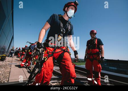 members of the Cologne Firefighters is seen on top of Kranhaus during the emergency recue from over 300m tall Kranhaus in Cologne, Germany on June 14, 2021. (Photo by Ying Tang/NurPhoto) Stock Photo
