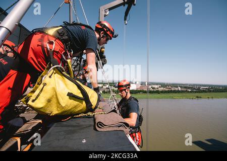members of the Cologne Firefighters are seen on top of the Kranhaus during the emergency recue from over 300m tall Kranhaus in Cologne, Germany on June 14, 2021. (Photo by Ying Tang/NurPhoto) Stock Photo