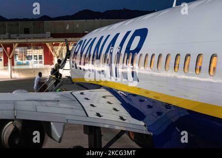 Passengers are seen boarding on a Boeing 737-800 aircraft with registration EI-EFN of Ryanair, the Irish Low Cost Airline Carrier at Chania Airport CHQ in Crete Island in Greece after the sunset. Travelers need to have prove of vaccination or Covid-19 Coronavirus negative test and wear a mandatory face mask, a measure because of the pandemic. Crete is a popular holiday destination. Chania, Greece on June 13, 2021 (Photo by Nicolas Economou/NurPhoto) Stock Photo