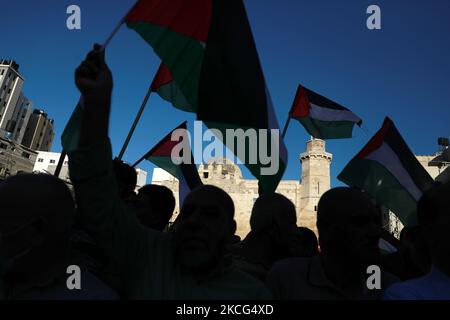 Palestinians take part in a protest over a flag-waving procession by far-right Israeli groups in and around East Jerusalem's Old City, in Khan Younis in the southern Gaza Strip June 15, 2021. (Photo by Majdi Fathi/NurPhoto) Stock Photo
