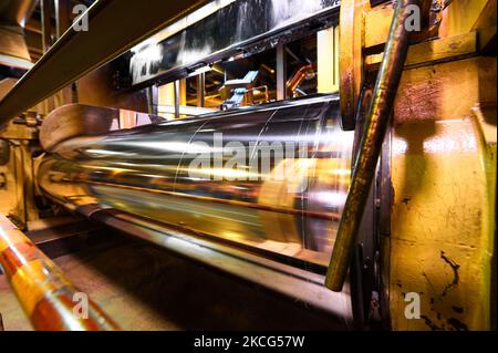 Shiny metal roller and steel cable processing in workshop Stock Photo