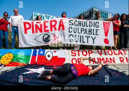 Chilean people are holding banners and flags in front of the ICC building, during a demonstration in support of Former Spanish judge Baltasar Garzon against Chilean's president Pinera, in The Hague, Netherlands on June 18th 2021. (Photo by Romy Arroyo Fernandez/NurPhoto) Stock Photo