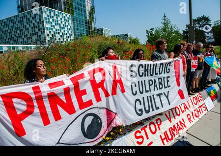 Chilean people are holding banners and flags in front of the ICC building, during a demonstration in support of Former Spanish judge Baltasar Garzon against Chilean's president Pinera, in The Hague, Netherlands on June 18th 2021. (Photo by Romy Arroyo Fernandez/NurPhoto) Stock Photo