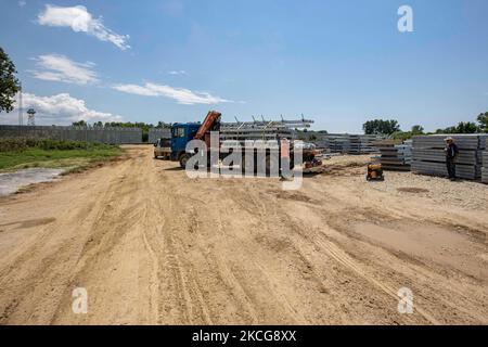 Work in progress, constuction of the new fence. Greece is reinforcing the Greek Turkish borders with personnel, cameras, drones, heavy vehicles, FRONTEX officers but also with a 5 meter tall fence. The fence is actually a concrete filled, a construction for at least 40KM, a long coverage in the wetlands of Evros river (Meric in Turkish), Greece's river border with Turkey. EU is supporting the border fortification financially. Asylum seekers, migrants and refugees used Evros as an entrance point to Europe, while in March 2020 a huge wave of thousands of people tried to cross the borders. Poros  Stock Photo