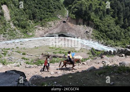 A man rides horse during hot summer day in Naranag about 55 Kilometres from Srinagar, Indian Administered Kashmir on 22 June2021. (Photo by Muzamil Mattoo/NurPhoto) Stock Photo