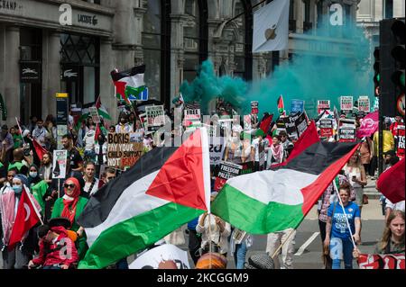 LONDON, UNITED KINGDOM - JUNE 26, 2021: Protesters wave Palestinian flags as they march through central London during People's Assembly Against Austerity National Demonstration on June 26, 2021 in London, England. Demonstrators from various organisations protest against the Government's handling of the coronavirus pandemic and demand the renationalisation of key industries, combating institutional racism and action on the climate emergency. (Photo by WIktor Szymanowicz/NurPhoto) Stock Photo