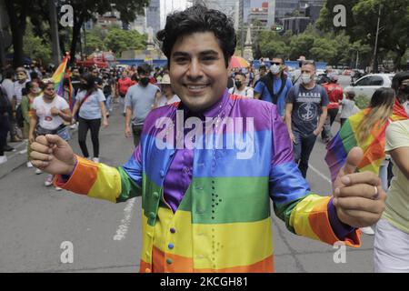 A member of the LGBTTTIQA community dressed as Mexican singer Juan Gabriel, in front of the Angel of Independence in Mexico City on the occasion of the LGBT+ Pride March in Mexico during the COVID-19 health emergency and the yellow epidemiological traffic light in the capital. (Photo by Gerardo Vieyra/NurPhoto) Stock Photo