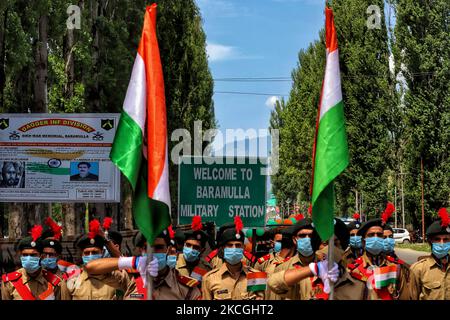 Welcome To Baramulla Military Station written on a board as NCC Cadets holding Indian National Flags getting ready to participate in an Event in Baramulla, Jammu and Kashmir, India on 27 June 2021. (Photo by Nasir Kachroo/NurPhoto) Stock Photo