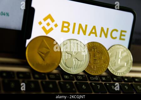 Binance logo displayed on a phone screen and representation of cryptocurrencies are seen in this illustration photo taken in Krakow, Poland on June 28, 2021 (Photo by Jakub Porzycki/NurPhoto) Stock Photo