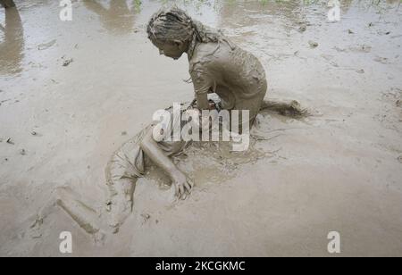 Nepalese People play in the mud as they plant rice saplings during National Paddy Day also called Asar Pandra, which marks the start of the annual rice planting season, in Bhaktapur , Nepal, June 29, 2021. (Photo by Saroj Baizu/NurPhoto) Stock Photo