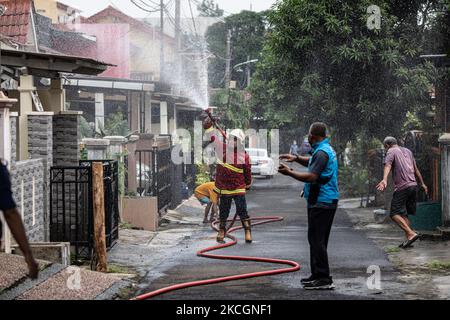 Firefighters from south tangerang spray disinfectant in Pamulang, South Tangerang, Banten, Indonesia on July 1, 2021. The implementation of disinfectants in Indonesia has been increased due to the second wave of Covid-19 attacks with new variants. (Photo by Donal Husni/NurPhoto) Stock Photo