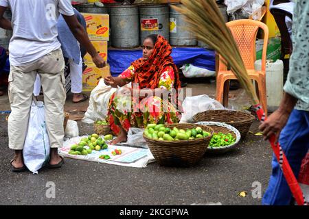 A woman sales vegetable at a vegetable market during the strict Covid-19 Coronavirus lockdown in Dhaka, Bangladesh, on July 2, 2021. Bangladeshi authorities imposed the nationwide all-out lockdown for week-long amid increasing coronavirus infections and coronavirus related deaths in the country. (Photo by Mamunur Rashid/NurPhoto) Stock Photo