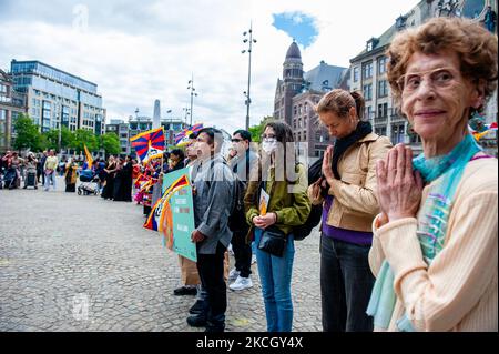 People gathered at the Dam Square is praying, during the Dalai Lama 86th birthday celebration in Amsterdam, on July 6th, 2021. (Photo by Romy Arroyo Fernandez/NurPhoto) Stock Photo