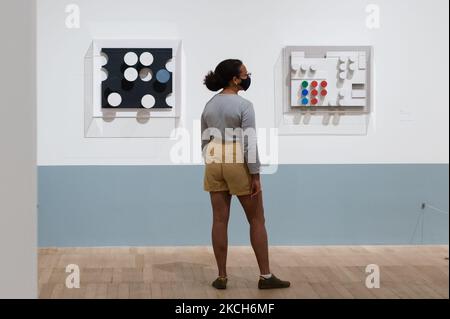 LONDON, UNITED KINGDOM - JULY 13, 2021: A gallery staff member looks at two artworks titled 'Relief' (both 1936) by Sophie Taeuber-Arp during a photocall to promote the new exhibition at Tate Modern on July 13, 2021 in London, England. The exhibition (15 July – 17 October 2021) will be the first in the UK to showcase the works of Sophie Taeuber-Arp (1889-1943), one of the most innovative artists and designers of the 20th-century avant-garde, tracing her accomplished career as a painter, architect, teacher, writer, and designer of textiles, marionettes and interiors. (Photo by WIktor Szymanowic