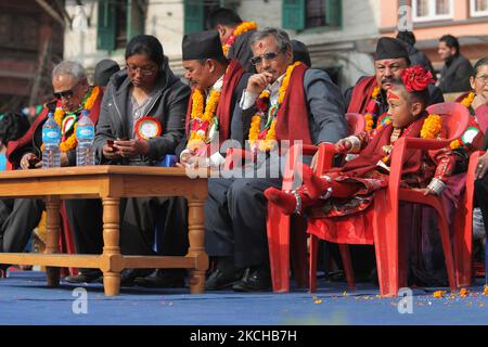 Pratikcha Maharjan aged 5 years, known as the Nepalese Living Goddess Kumari sits among dignitaries and politicians during a special program to promote respect for senior Newari women at the Hanuman Dhoka in Kathmandu, Nepal, on December 06, 2011.. A Kumari is a young girl of the Shakya clan, between 4 and 7 years of age that is chosen based on 32 characteristics, horoscope and a series of tests, to house the spirit of the goddess Taleju Bhawani (an aspect of the Goddess Durga). The chosen girls remain Kumaris until they reach puberty, or shed blood. Kumari, who appears in public only thirteen Stock Photo