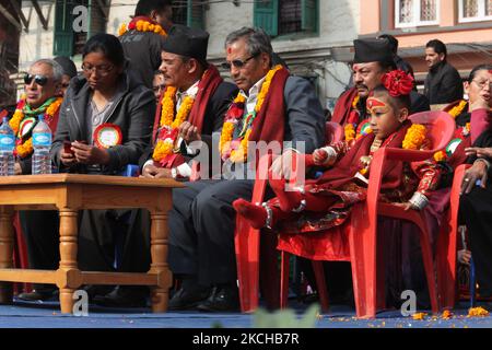 Pratikcha Maharjan aged 5 years, known as the Nepalese Living Goddess Kumari sits among dignitaries and politicians during a special program to promote respect for senior Newari women at the Hanuman Dhoka in Kathmandu, Nepal, on December 06, 2011.. A Kumari is a young girl of the Shakya clan, between 4 and 7 years of age that is chosen based on 32 characteristics, horoscope and a series of tests, to house the spirit of the goddess Taleju Bhawani (an aspect of the Goddess Durga). The chosen girls remain Kumaris until they reach puberty, or shed blood. Kumari, who appears in public only thirteen Stock Photo