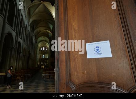A sign that reads 'Wearing a mask is Compulsory' at the entrance to the Abbey of Saint-Étienne, also known as Abbaye aux Hommes, in Caen. On Wednesday, July 20, 2021, in Caen, Calvados, Normandy, France. (Photo by Artur Widak/NurPhoto) Stock Photo