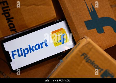 Flipkart logo displayed on a phone screen and Flipkart website displayed on a laptop screen are seen in this illustration photo taken in Tehatta, West Bengal, India on July 24, 2021. Walmart-owned e-commerce firm Flipkart said it has eliminated all single-use plastic packaging used by introducing the most scalable sustainable alternatives eco-friendly materials across its fulfillment centres in India. The Bengaluru-based firm has also ensured it is fully compliant with all EPR (extended producer responsibility) rules and through its network of recyclers; the equivalent quantity of single-use p Stock Photo
