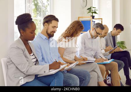 Group international business people studying writing making notes listening presentation in office. Stock Photo