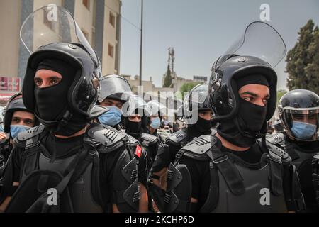 Riot police members seen during a demonstration held near the Tunisian parliament, in the city of Bardo, in the capital Tunis, Tunisia on July 25, 2021 to call for the fall of the regime, the dissolution of the parliament and to demand Hichem Mechichi’s government step down. (Photo by Chedly Ben Ibrahim/NurPhoto) Stock Photo