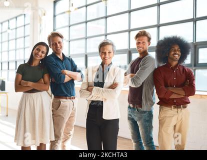 Were the best in the business. Portrait of a team of happy designers posing confidently in their modern office. Stock Photo